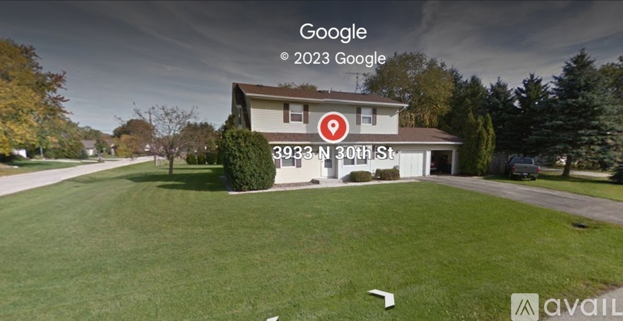 A house with a lawn in front of it is shown.