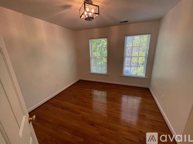 A dining room with a table and chairs.
