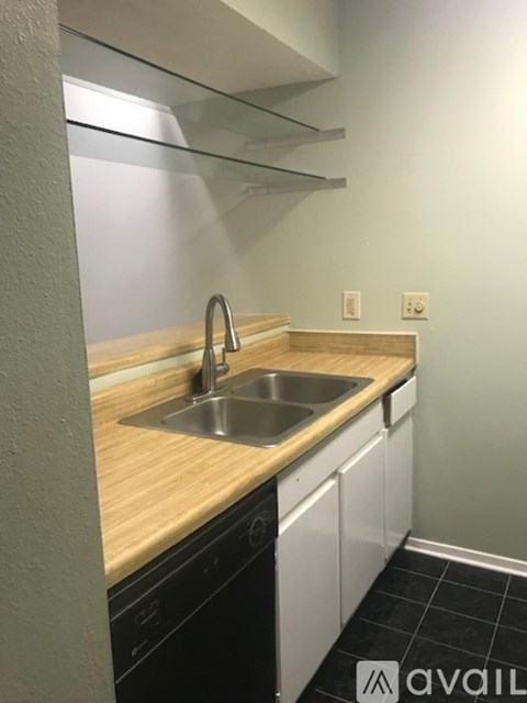 A kitchen with a sink and a counter.