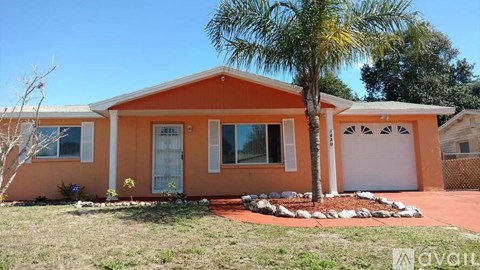 A house with a palm tree in front.