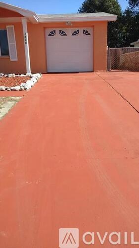 A house with a white garage door and a driveway.