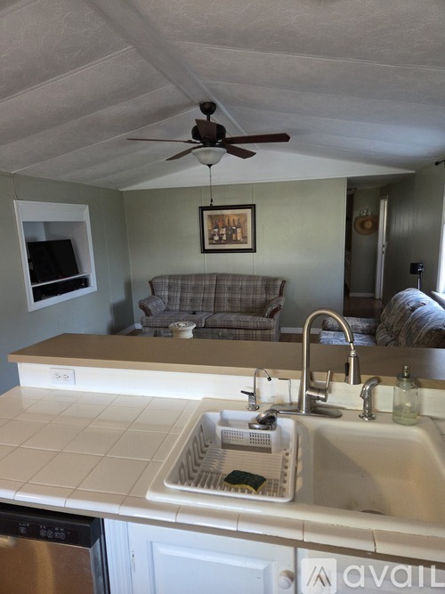 A kitchen with a sink and a fan.