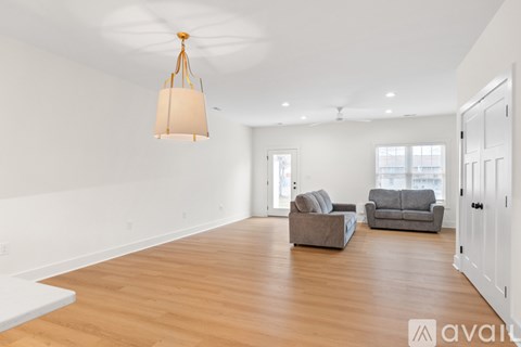 A living room with a grey couch and a white table.
