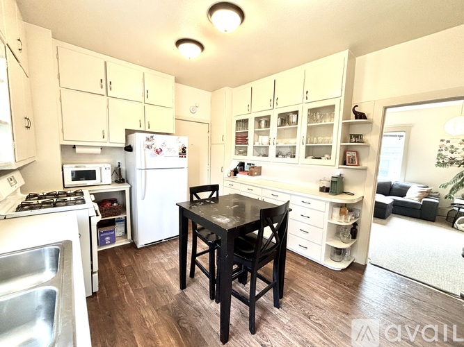 A kitchen with a table and chairs in the middle of it.