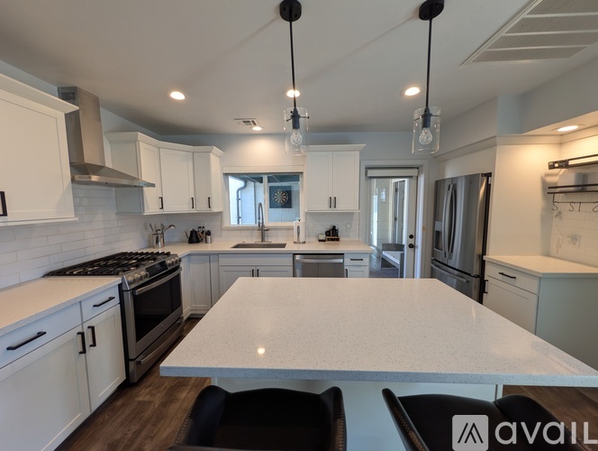 A modern kitchen with white cabinets and a large island.