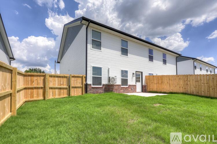 A house with a white exterior and a brown fence.