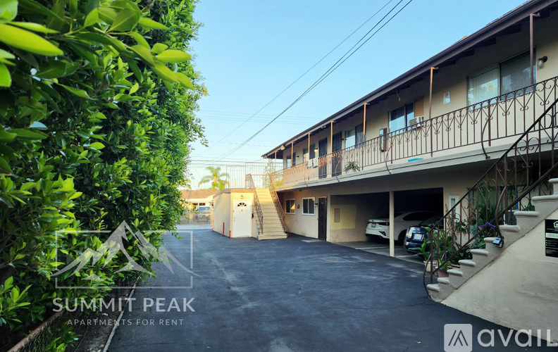 A parking lot in front of a building with the text "Summit Peak Apartments for Rent" on the image.