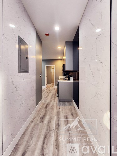 A modern kitchen with a marble floor and walls.