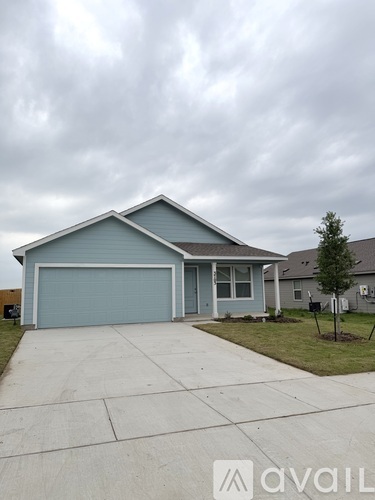 A two-car garage with a blue door and a grey roof.
