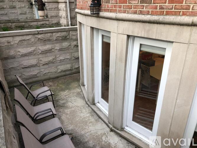 A balcony with a bench and a window.
