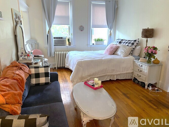 A bedroom with a bed, dresser, and mirror.