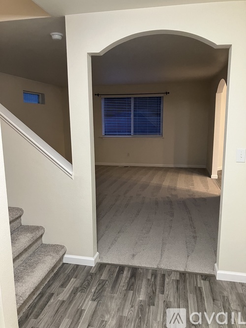 A hallway with a staircase leading to the second floor.