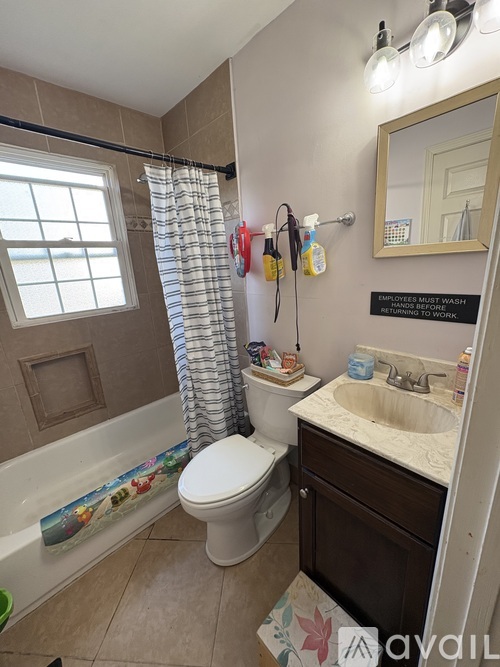 A bathroom with a toilet, sink, and shower.