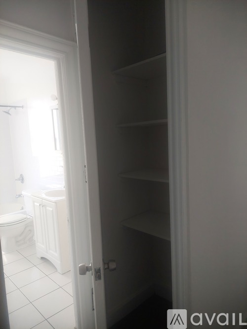 A white door is open to a bathroom.