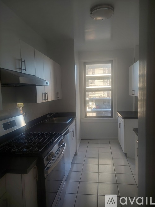 A kitchen with black countertops and white cabinets.