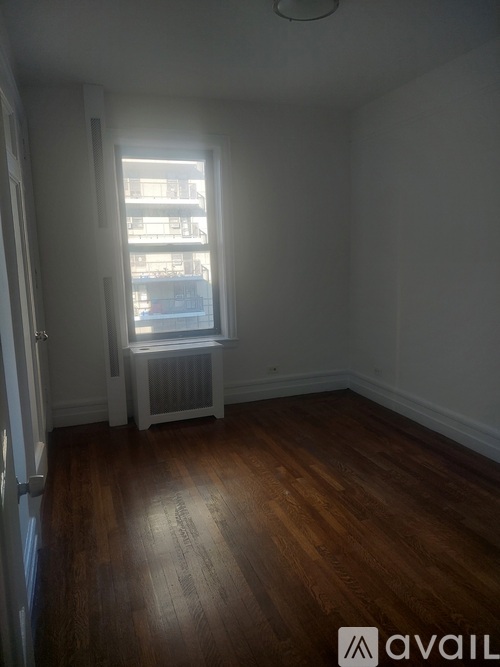 A room with wooden floors and a window.