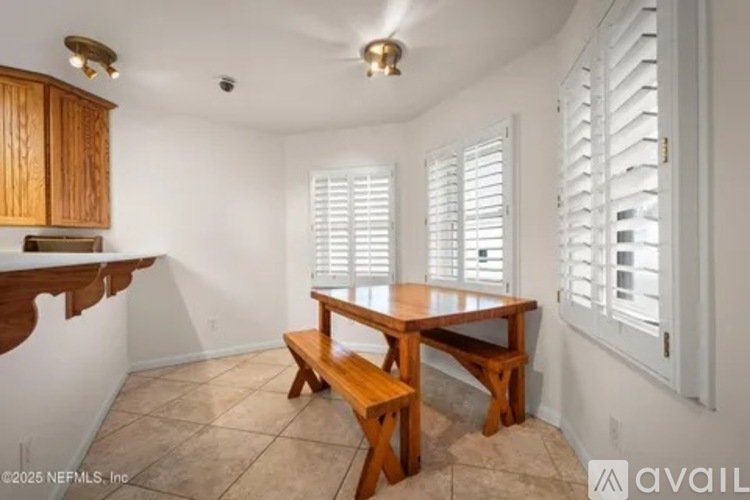 A dining room with a wooden table and bench.