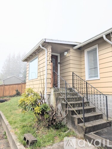A house with a staircase leading to the front door.
