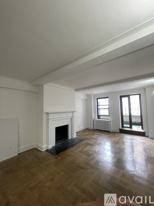 A room with a fireplace and wooden floors.
