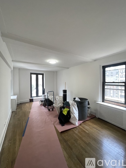 A room with a pink yoga mat on the floor.