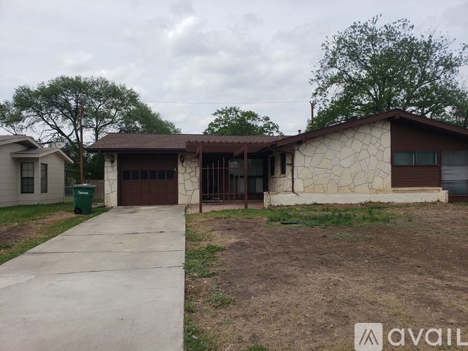 A house with a brown roof and a brown garage door is available for rent.