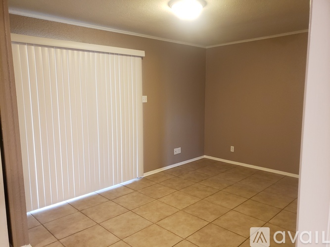 A room with beige walls and a tiled floor.