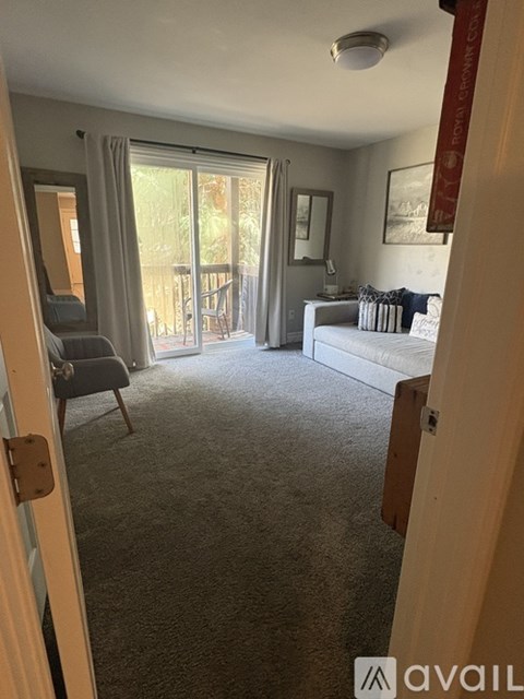A living room with a grey sofa and a grey armchair.
