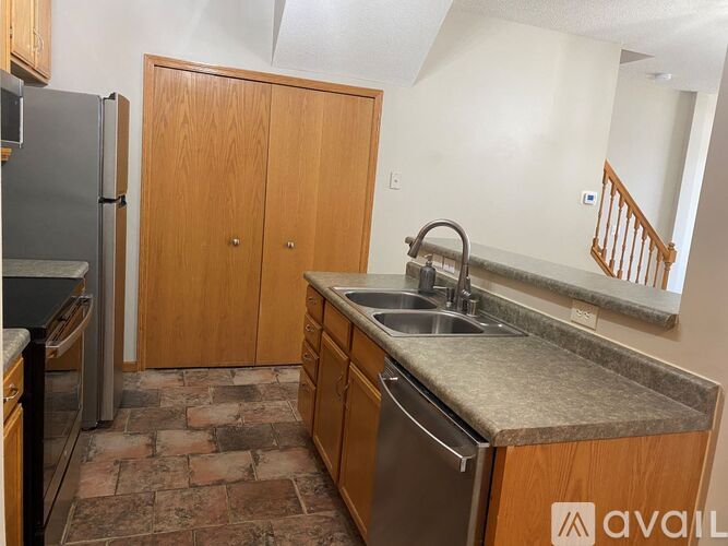 A kitchen with a sink and a refrigerator.
