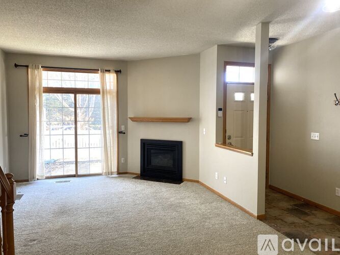 A living room with a fireplace and sliding glass doors.