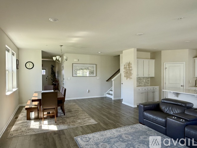 A living room with a dining table and chairs.