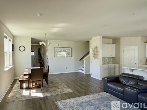 A living room with a dining table and chairs.