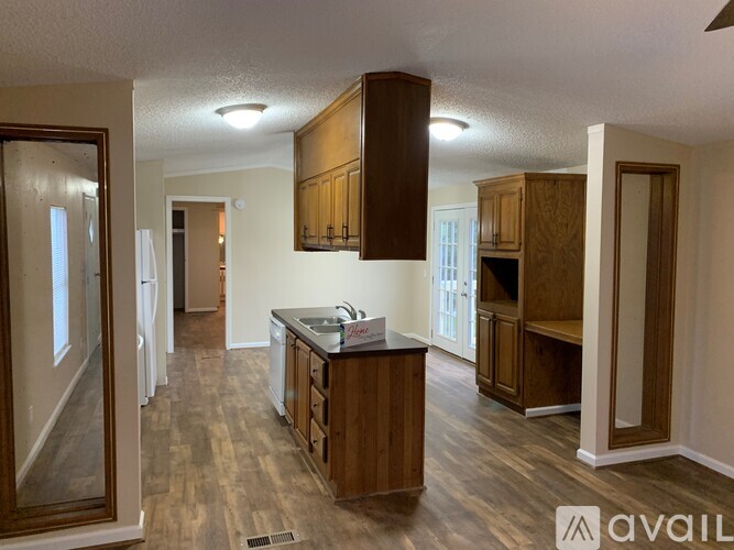 A kitchen with wooden cabinets and a sink.