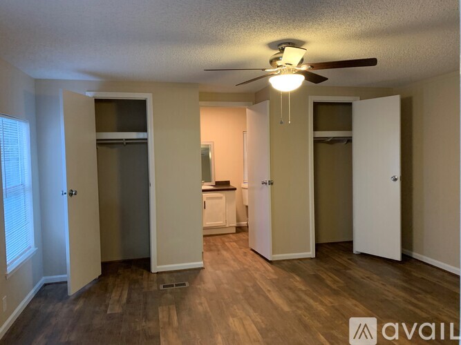 A room with a ceiling fan and a washer and dryer in it.