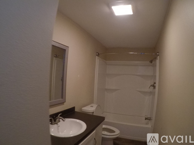 A bathroom with a sink, toilet and bathtub.