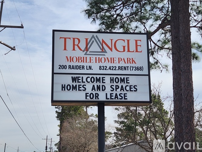 A sign for Triangle Mobile Home Park is displayed on a pole.