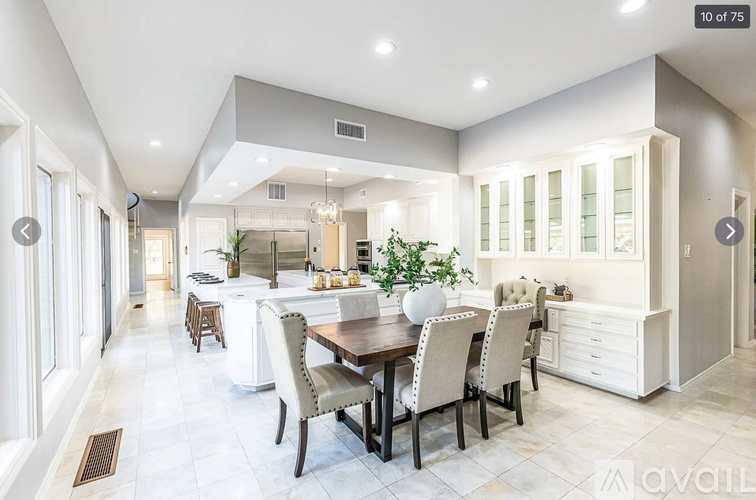 A spacious kitchen and dining area with a large table and chairs.