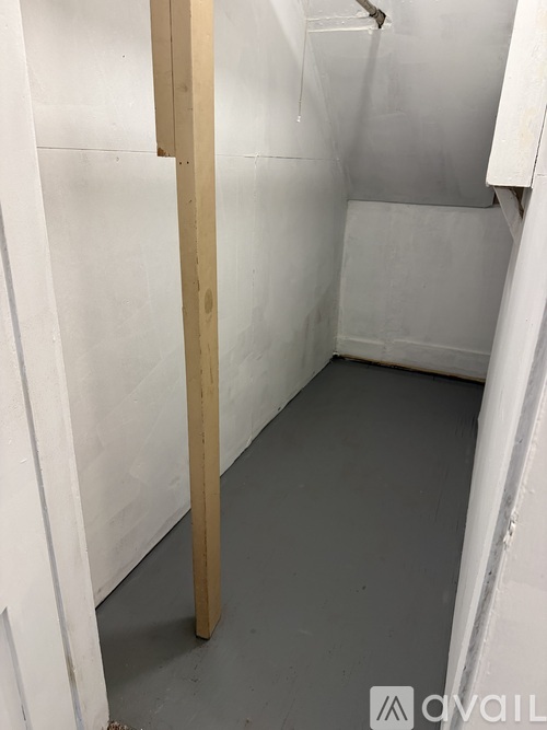 A bathroom with a wooden support beam in the corner.