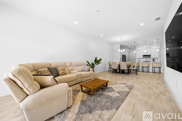 A living room with a large beige sofa and a coffee table.