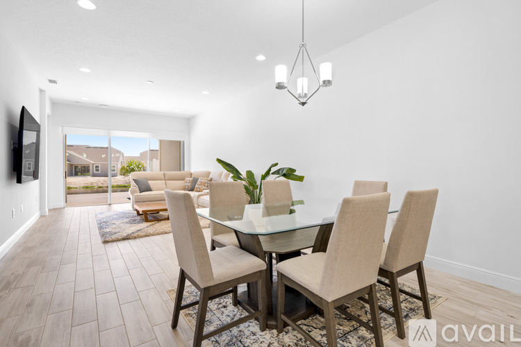 A modern dining room with a glass table and chairs.