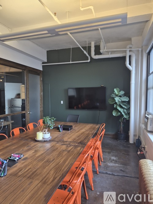 A conference room with a long table and chairs.