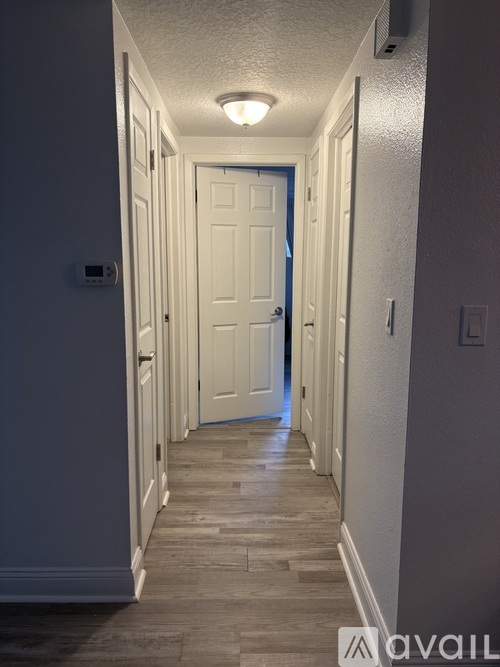 A long hallway with a door at the end.