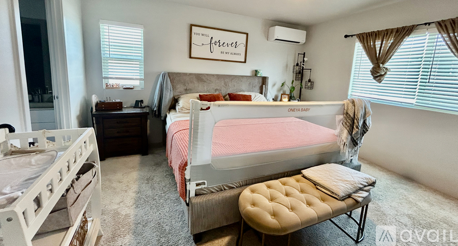 A bedroom with a bed, a bench, and a dresser.