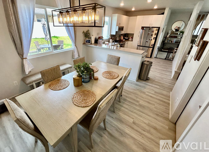 A modern dining room with a wooden table and chairs.