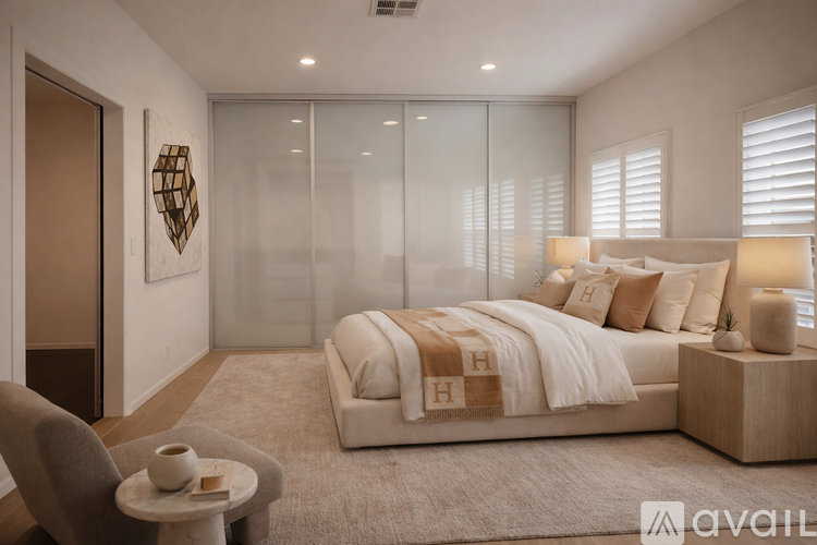 A modern bedroom with a large bed and a glass partition wall.