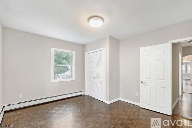 A room with a window and a door is available for rent.