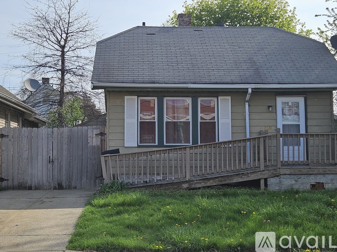 A house with a grey roof and a wooden fence.