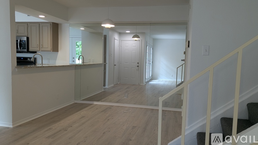 A kitchen with wooden floors and white walls.