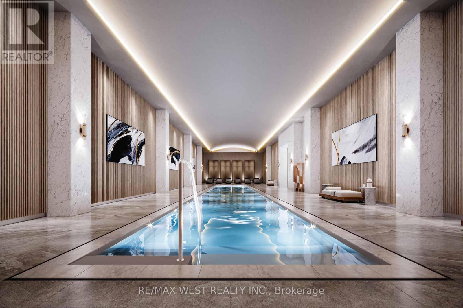 A long, narrow indoor swimming pool with a light blue color.