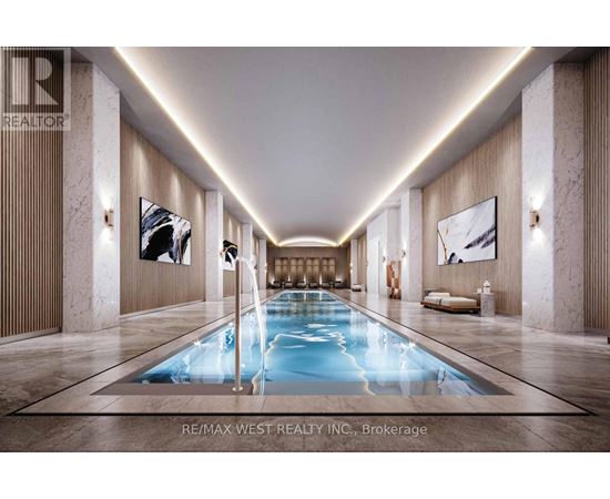 A long, narrow indoor swimming pool with a light blue color.