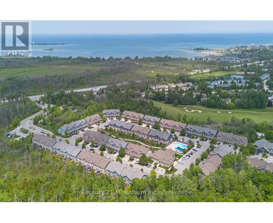 A bird's eye view of a residential area with houses and a swimming pool.
